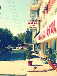 a sign for a market outlet on a city street at Marka Hotel in Antalya