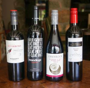 three bottles of red wine sitting on a table at Castle Inn in Newport Pembrokeshire