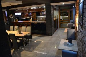 a restaurant with a table and chairs and a bar at OSRODEK WCZASOWY HANKA in Zawoja