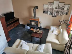 a living room with a couch and a fireplace at Ferienhaus am Mattheiser Wald in Trier