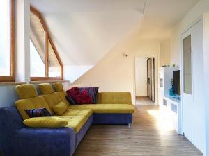 a living room with a couch and a tv at Apartments Katja in Kranjska Gora