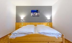 Postel nebo postele na pokoji v ubytování Hotel Heigl