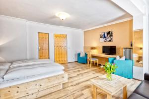 a bedroom with a large bed and a desk at Hotel Heigl in Munich