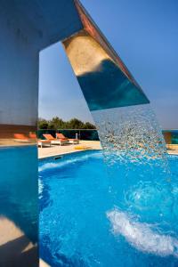 a pool with water pouring out of it at Princess Of Naxos in Naxos Chora