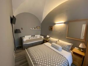 a bedroom with a bed and a bath tub at B&B Corte Santa Maria in Rovereto