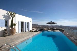 a swimming pool with a view of a house at Mykonos Psarrou villas for 18 people in Mýkonos City