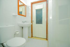 a bathroom with a toilet and a sink and a shower at Hotel Nawathana in Matara