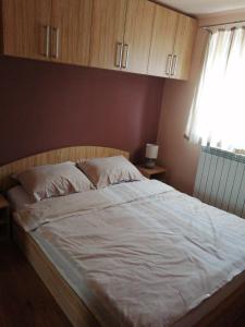 a bedroom with a large white bed with a window at Valnea in Viskovo