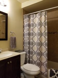 a bathroom with a toilet and a shower curtain at Quiet Desert Oasis off Swan Rd in Tucson