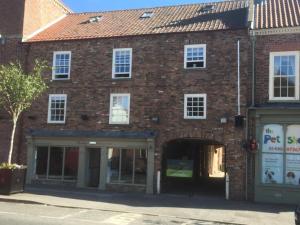 a large brick building with a large doorway at The Apartments in Market Weighton