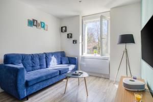 歐丹庫爾的住宿－Le 001-GregIMMO-Appart'Hôtel，客厅配有蓝色的沙发和桌子