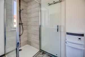 a shower with a glass door in a bathroom at Le 001-GregIMMO-Appart'Hôtel in Audincourt +24 photos