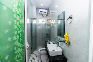 a bathroom with a toilet and a sink and a shower at Karry's House in Da Lat