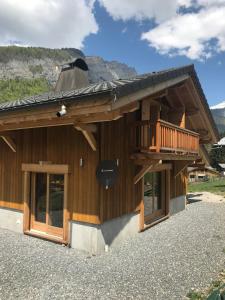 a building with a balcony on the side of it at Chalet La R'Batte in Sixt