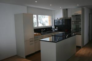 a kitchen with a sink and a counter top at Haus Rufinis in Klosters