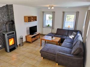 a living room with a couch and a fireplace at Ferienhaus Sächsische Schweiz in Kurort Gohrisch
