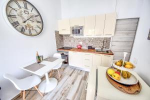 a kitchen with a table and a clock on the wall at White House - Piro in San Miguel de Abona