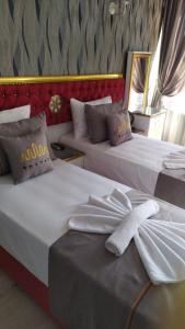 two beds in a hotel room with towels on them at RHYTHM HOTEL in Istanbul