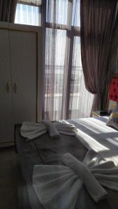 a bedroom with a large bed with windows at RHYTHM HOTEL in Istanbul