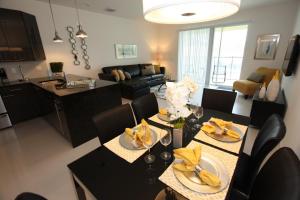 a kitchen and living room with a table and chairs at 17517 Dream in Orlando