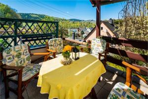 a yellow table and chairs on a balcony at Ferienwohnungen Weißflog in Schwarzenberg