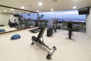 a gym with cardio equipment in a room with a view at Holiday Inn Express & Suites - Playa del Carmen, an IHG Hotel in Playa del Carmen