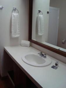 a bathroom with a white sink and a mirror at Hotel Posada Santa Rita in Mascota