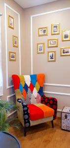 a living room with a colorful couch and pictures on the wall at Afonso Galo Guest Apartments II in Almada