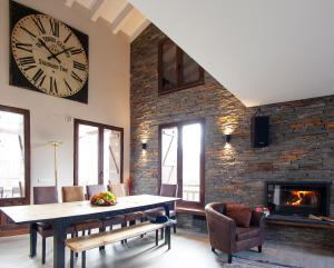 a dining room with a large clock on the wall at Casa del Ocejón in Majaelrayo