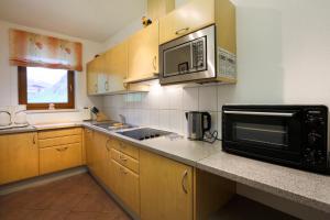 a kitchen with a microwave oven and a sink at Appartement Gisela in Sölden