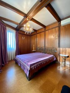 a bedroom with a bed in a room with wooden walls at On The River in Vishenki