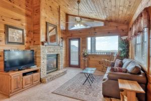 a living room with a television and a fireplace at All About Romance by Venture Smoky Mountains in Henderson Springs