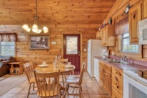 a kitchen with a table and chairs in a cabin at All About Romance in Henderson Springs