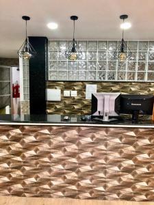 a kitchen with a bar with a counter top at Hotel Barão in Sao Paulo