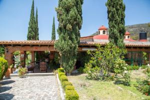 an exterior view of a house with trees at Hotel Quinta Mirador Zacualli in Bernal