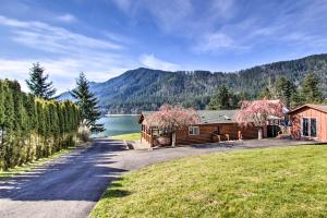 una cabaña de madera con una carretera junto a un lago en Lakefront Cabin with Stunning Mountain Views and Dock!, en Mineral