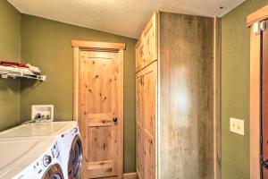 a laundry room with a washing machine and a door at Lakefront Eatonville Cabin w/ Dock & Mtn Views! in Mineral +25 photos