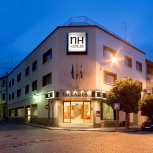 a large white building with a sign on it at NH Córdoba Califa in Córdoba