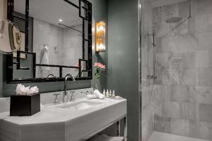 a bathroom with a sink and a shower at NH Collection Colón Valencia in Valencia