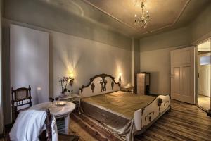 a bedroom with a large bed and a table at Pension Friedrich-Wilhelm in Berlin