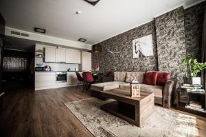 a living room with a couch and a table at Gandrališkės in Klaipėda