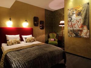 a bedroom with a large bed with a red headboard at Skanstulls Boutique Hostel in Stockholm