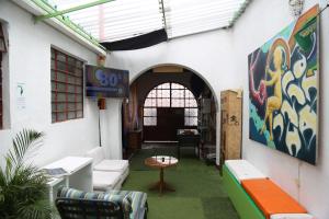 a room with a sign on the side of a building at Hostal CQ Chapinero in Bogotá