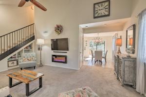 a living room with a fireplace and a tv at Flagstaff Townhome with Deck 10 Mi to Walnut Canyon in Flagstaff