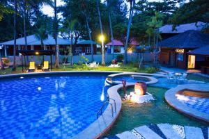 a large swimming pool in a backyard at night at Sutera Sanctuary Lodges At Manukan Island in Kota Kinabalu