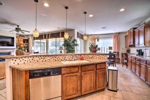 a kitchen with wooden cabinets and a counter top at Single-Story San Bernardino Home with Valley Views! in San Bernardino