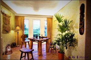 a room with a table and chairs and a window at The Dew B&B in Dongshan