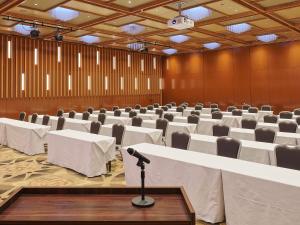 a conference room with tables and chairs and a microphone at APA Hotel & Resort Yokohama Bay Tower in Yokohama