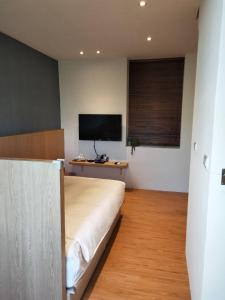 A television and/or entertainment centre at Light Blue Hostel