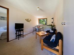 a living room with a couch and a table at The Broken Banyan in Lord Howe